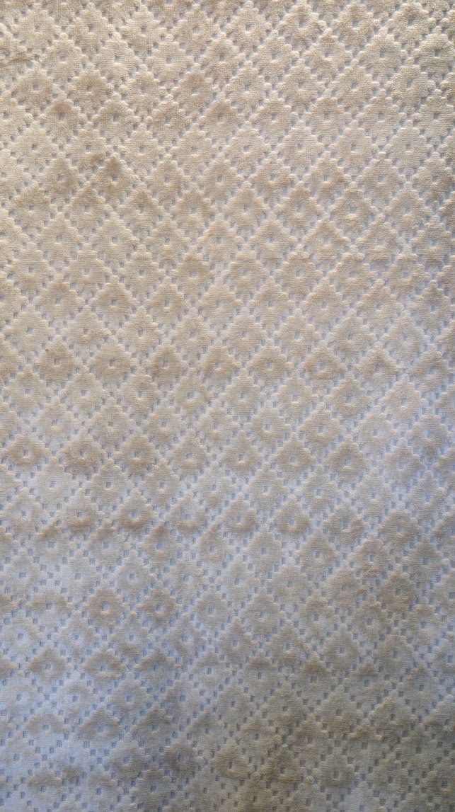 Handmade 8x10 rug with man-made silk pile in an ivory and pale blue diamond lattice